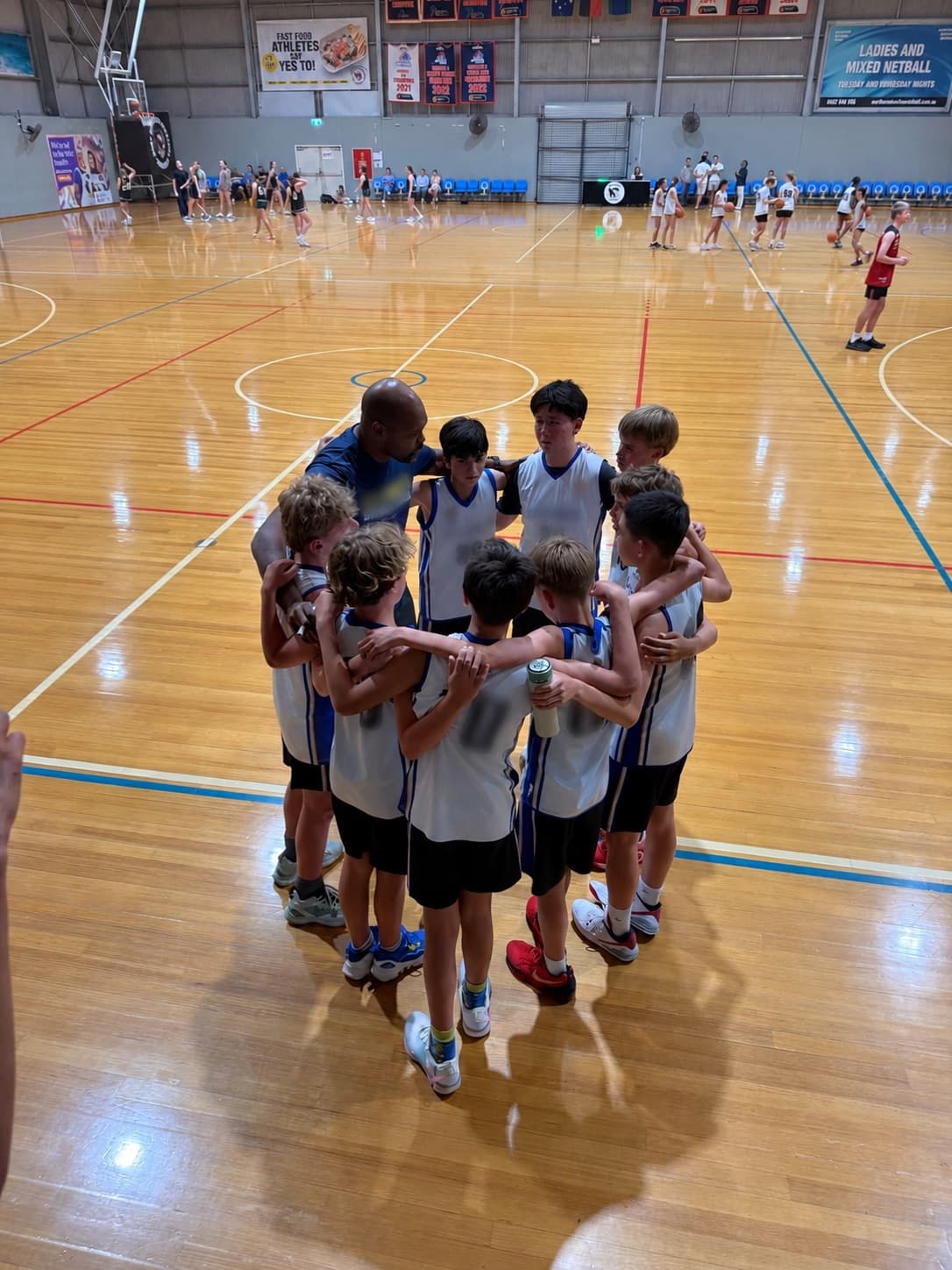 Ethan's basketball team in a huddle during a game