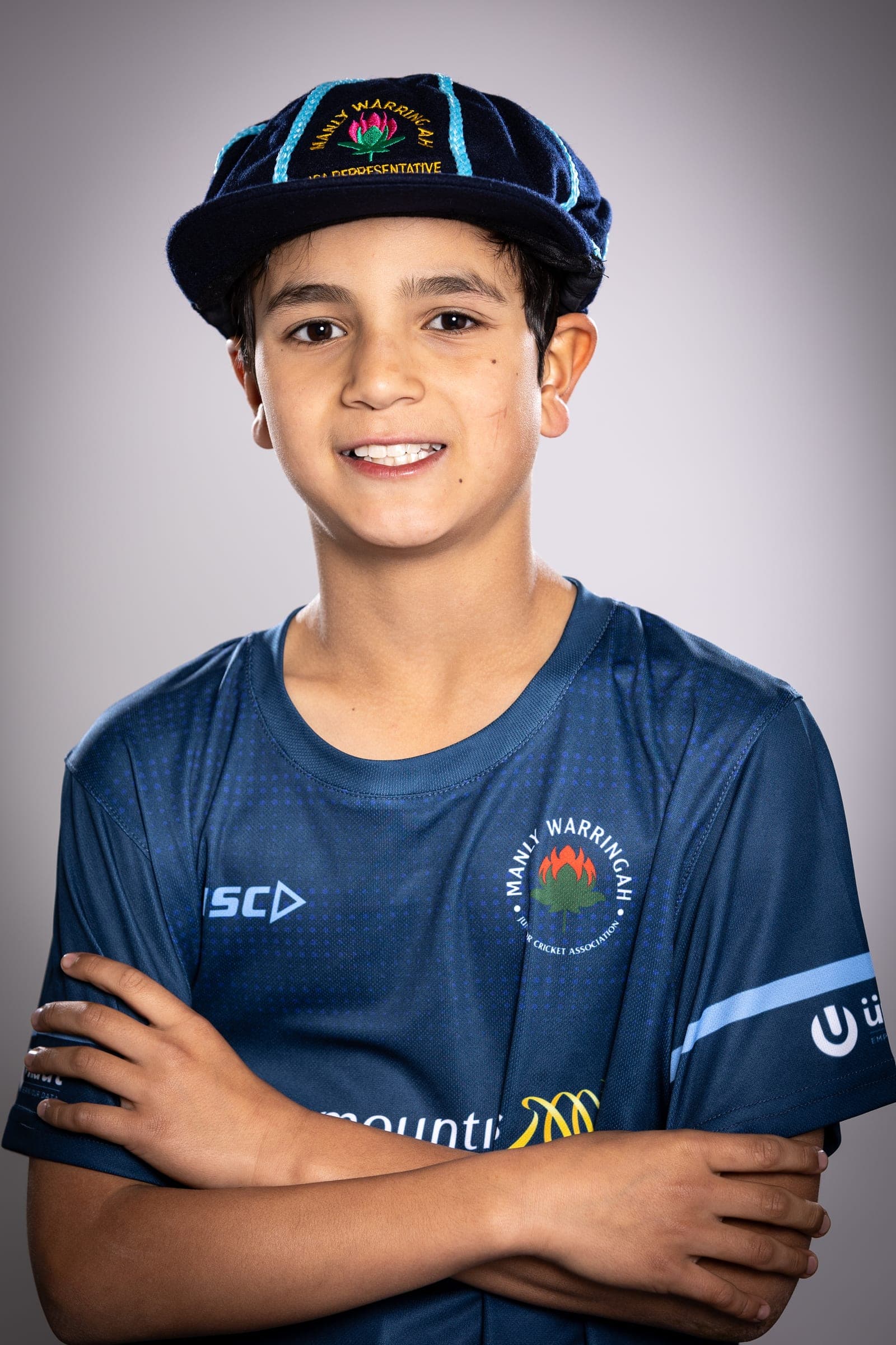 Portrait of Ethan wearing his Division 1 representative cricket cap